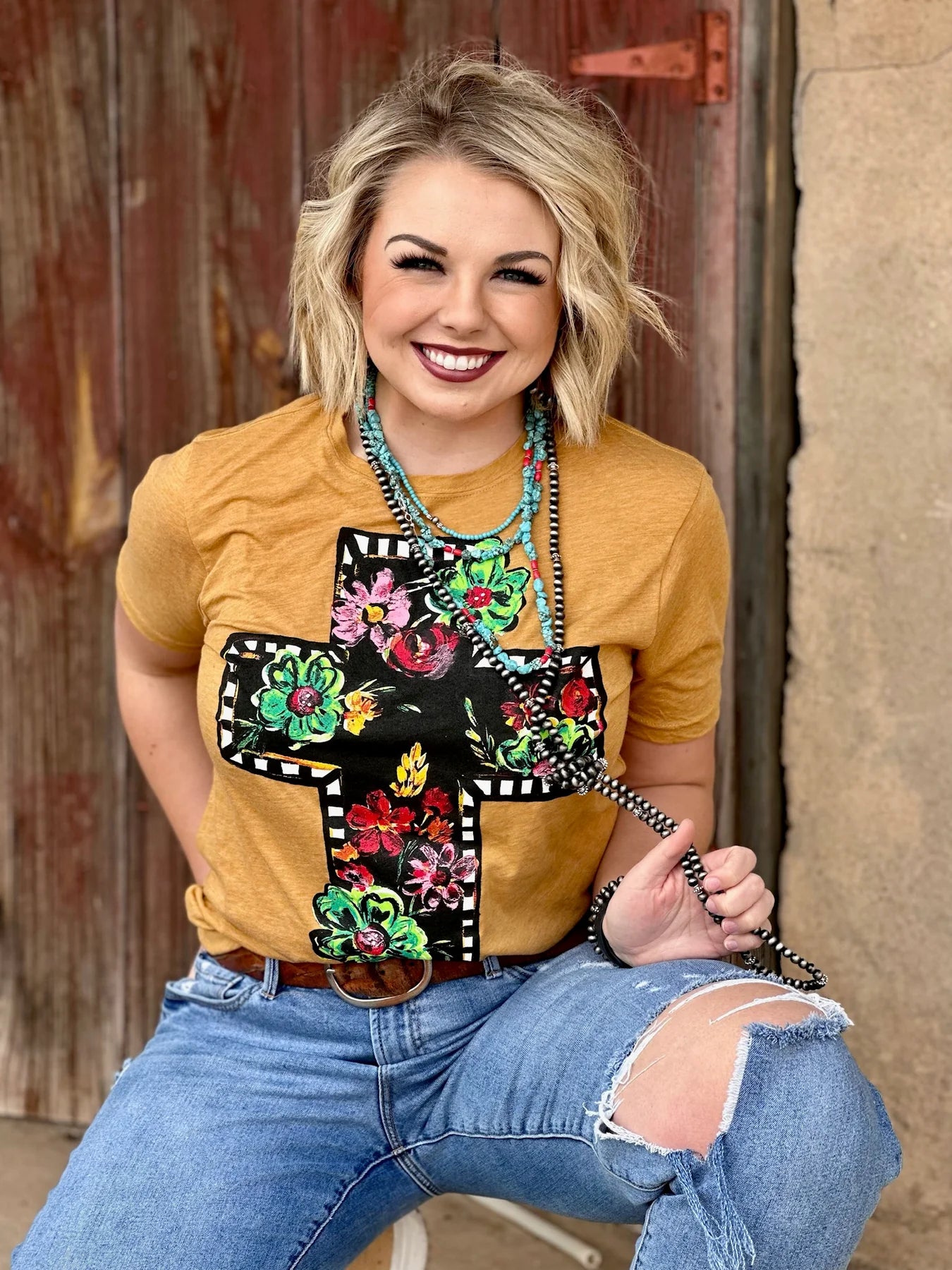 CALLIE'S BLACK FLORAL CROSS TEE ANTIQUE GOLD